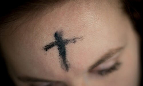 black cross on person's forehead